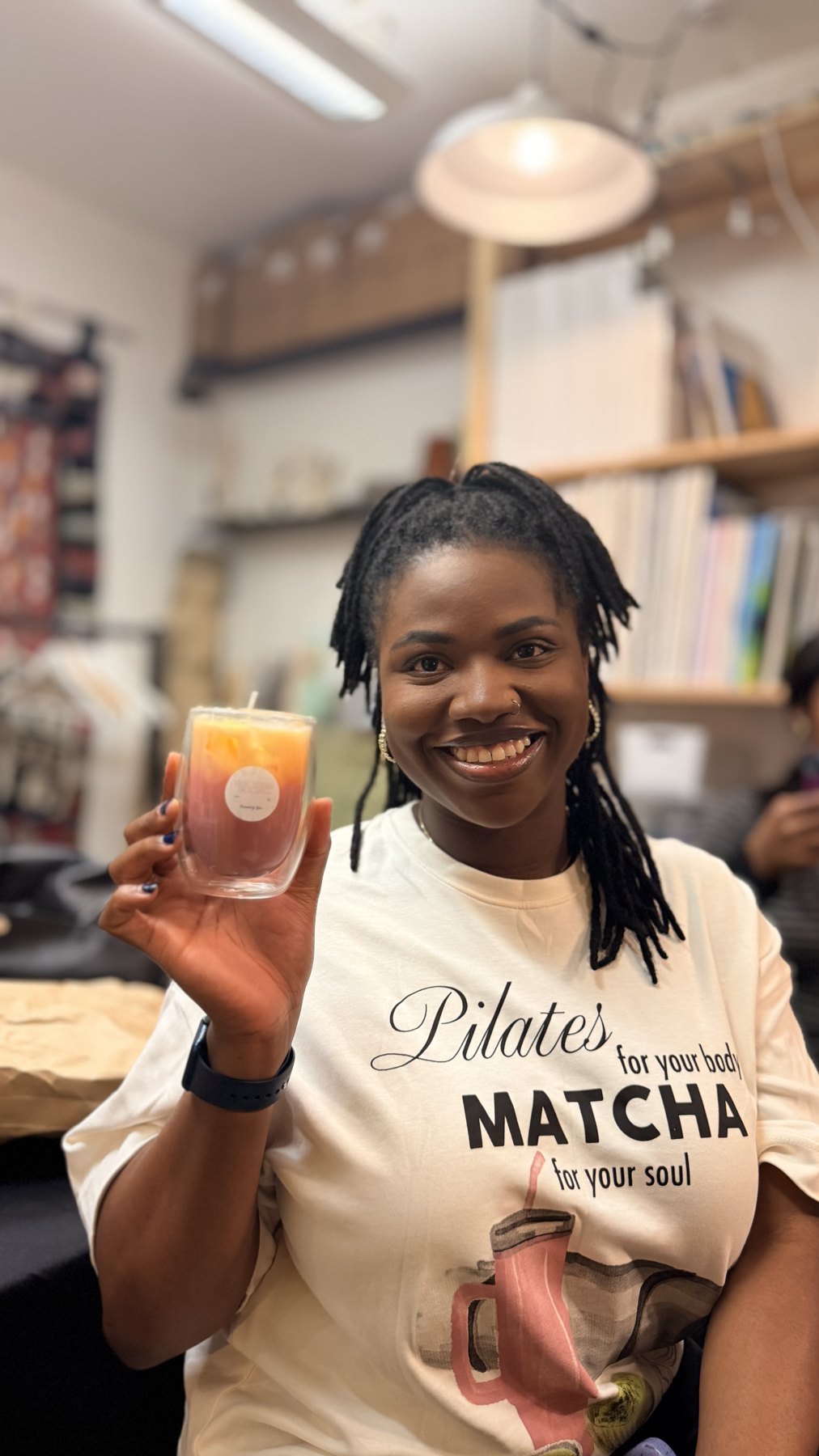 A smiling guest with her finished candle