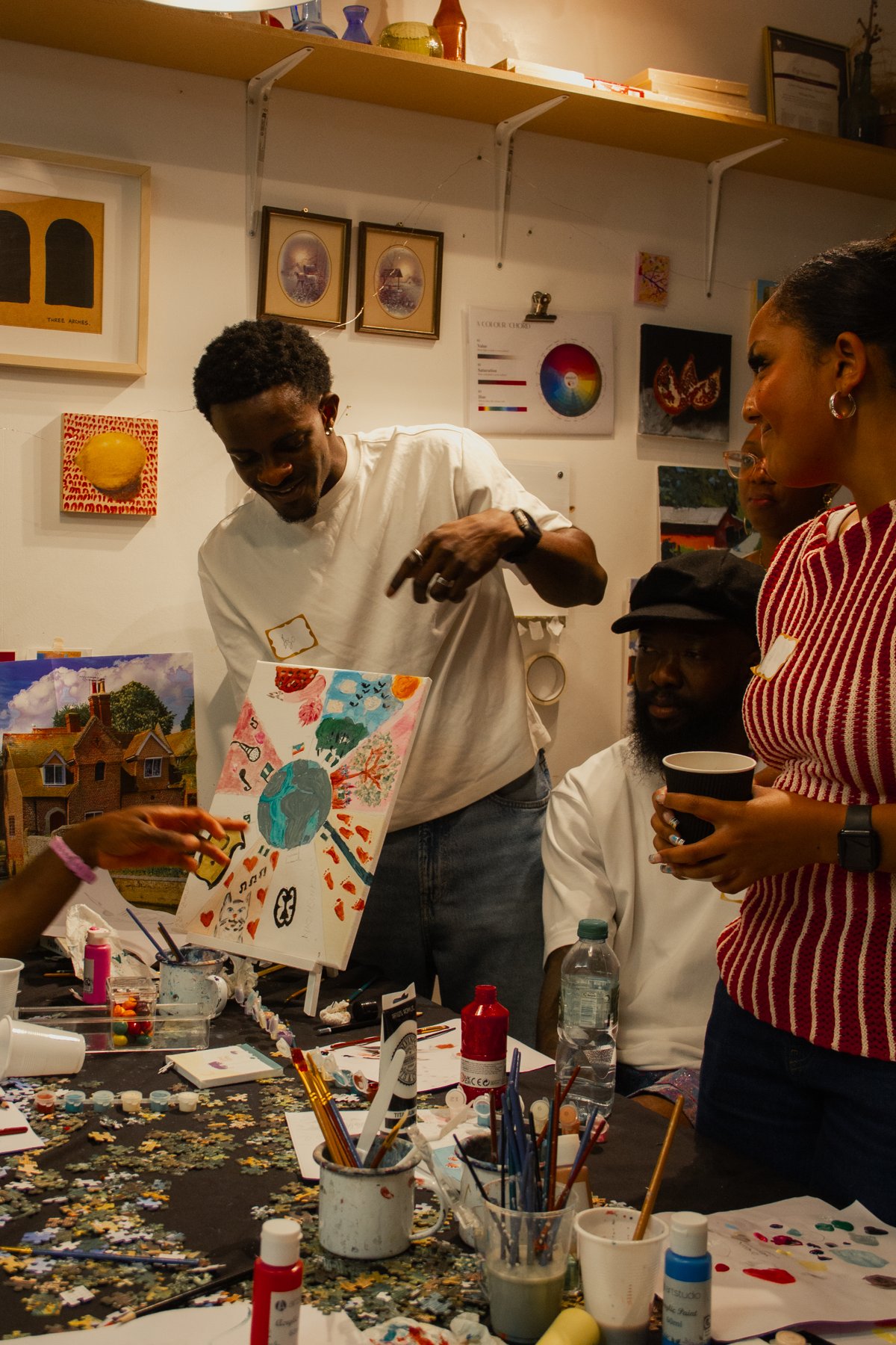 Two guests showing their finished paintings