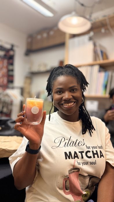 A smiling guest with her finished candle